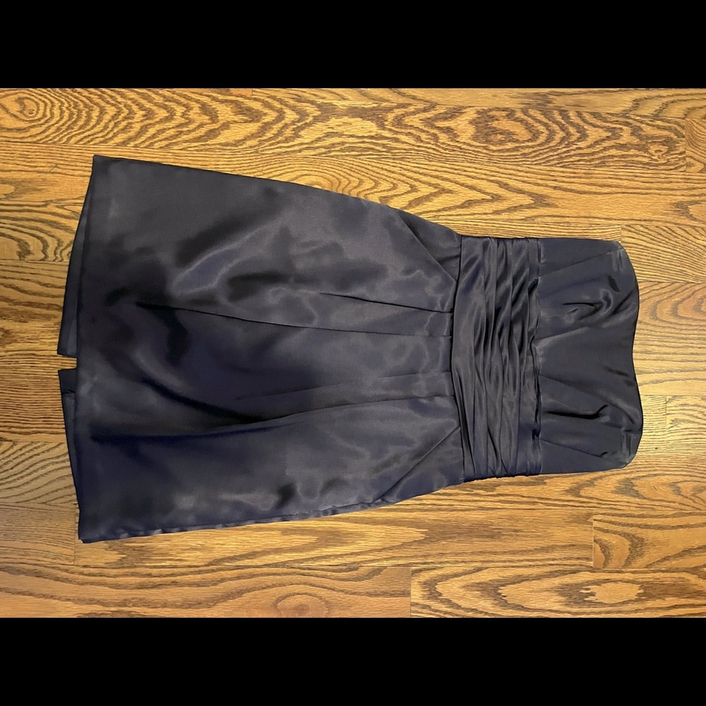 Dark purple strapless knee length dress with pockets.